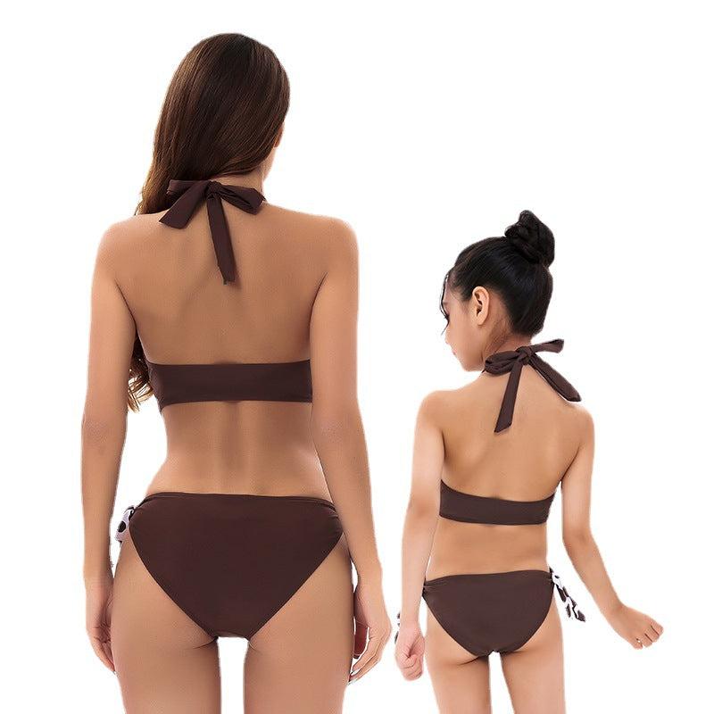 Close product view of mommy and me swimsuits with brown polka dot print