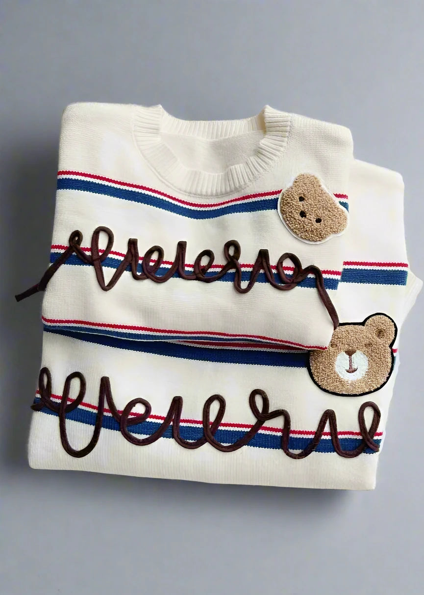 Matching family holiday sweater with 'Cheers' text and bear patch decoration