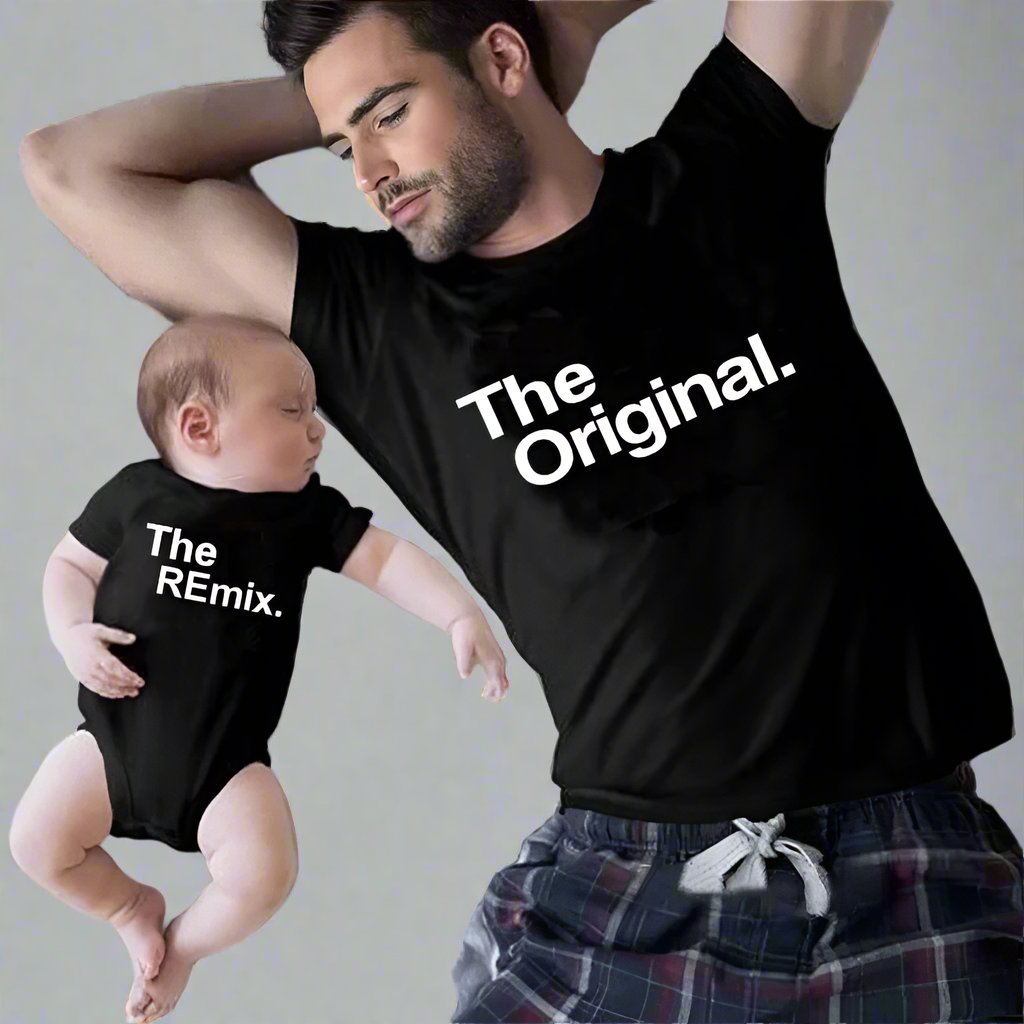 Father and newborn baby in matching black shirts reading 'The Original' and 'The Remix'