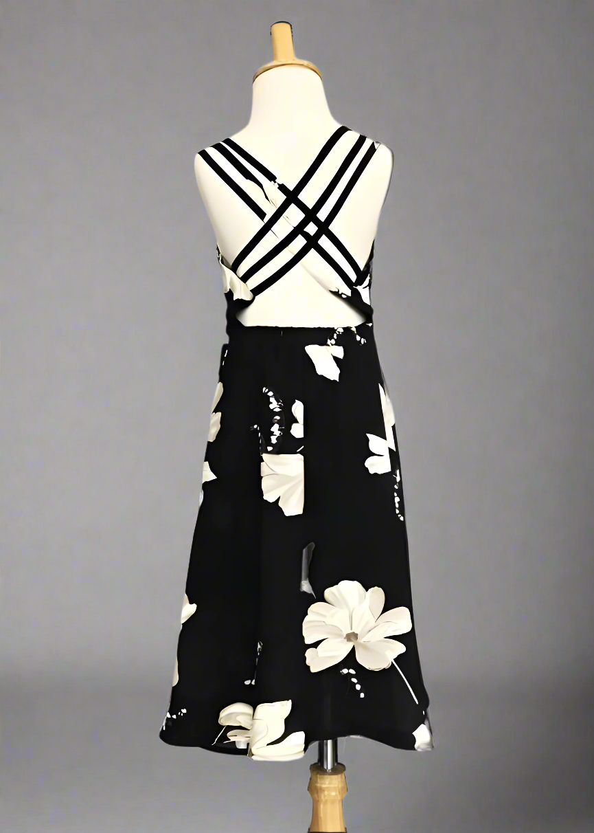 Mother and daughter wearing matching black floral dresses for a beach day