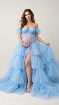Pregnant woman in a sky blue tiered tulle sweetheart maternity gown in a photo studio