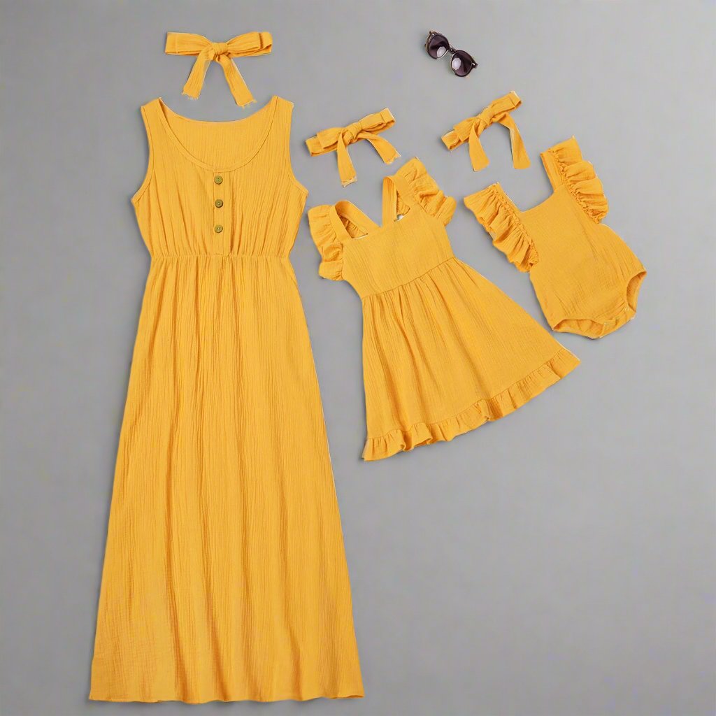 Matching yellow summer dresses for mom, daughter, and baby girl, with bows.