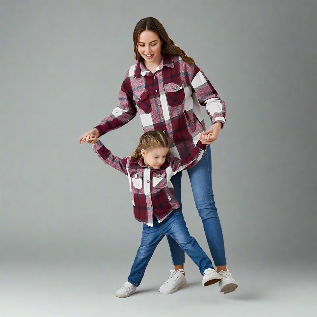Mother and child wearing matching green plaid shackets