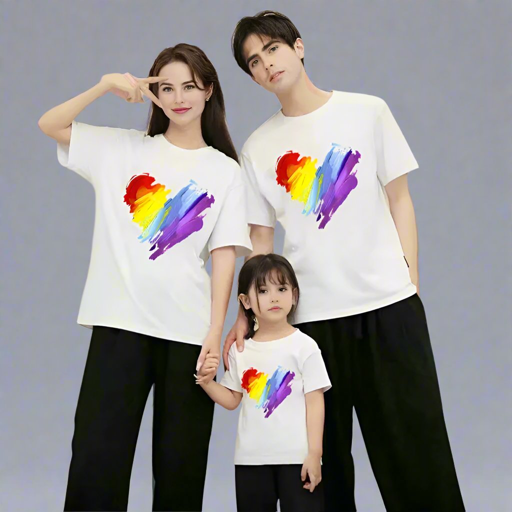 Family wearing matching t-shirts with a colorful heart brush stroke design, available in white, yellow, and red