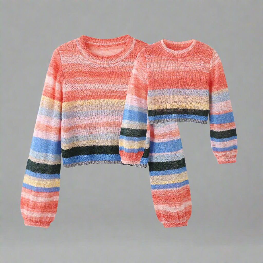 Parent and child matching cozy sweaters with rainbow stripe design
