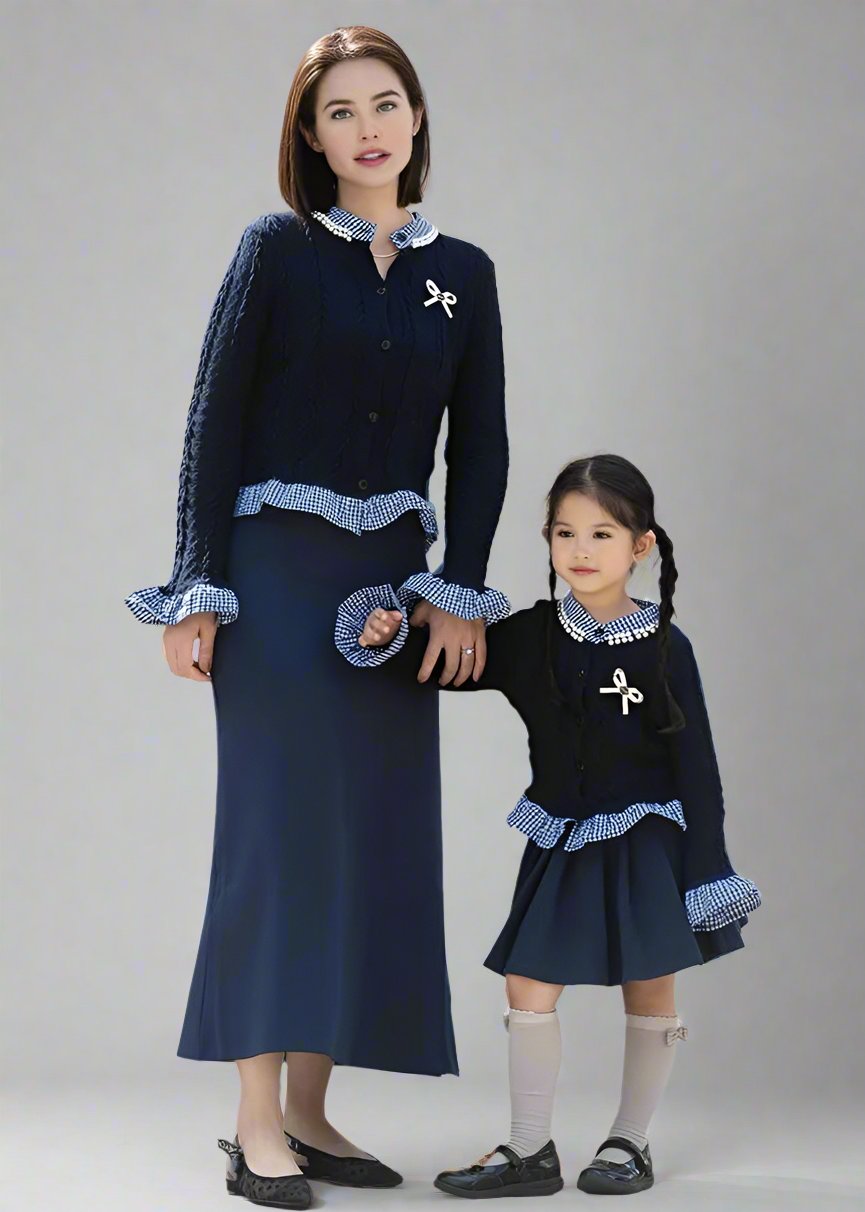 Mother and daughter wearing matching navy cardigans with gingham trim and navy skirts, ideal for elegant outings