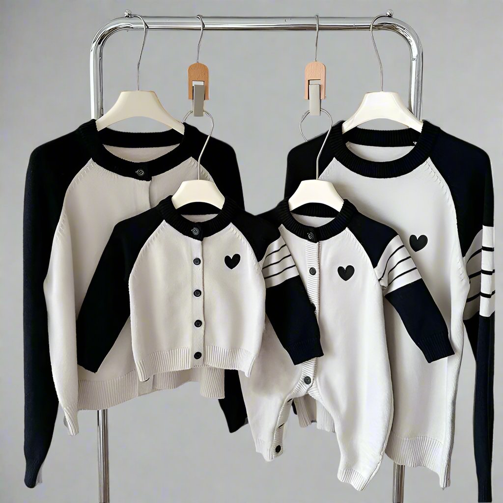 Family knit cardigans with cream body, heart motif, and contrasting sleeves in red and black
