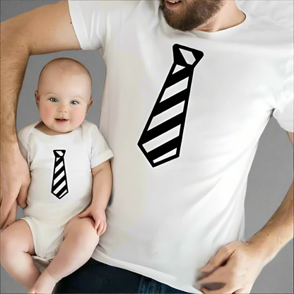 Father and child wearing matching tie-print shirts, black shirts with white striped tie design