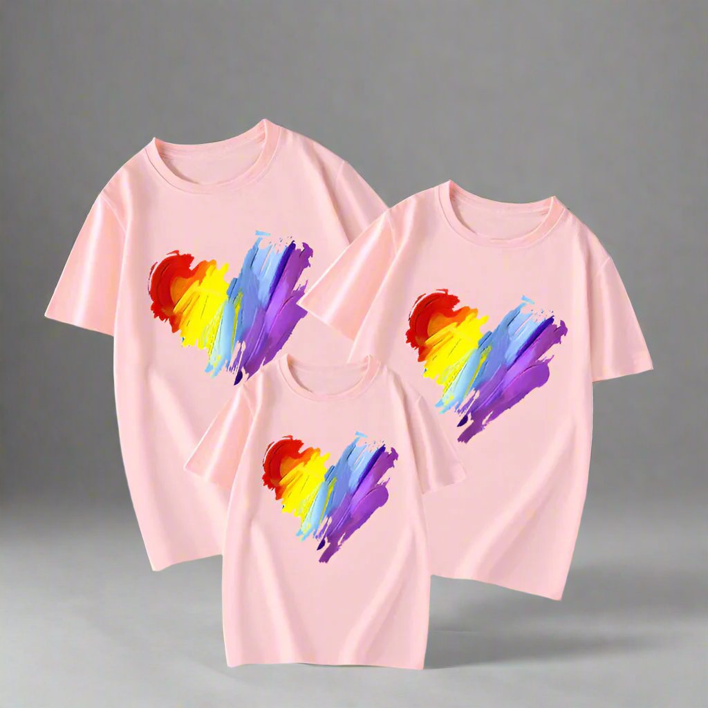 Close-up of family matching t-shirts with vibrant rainbow heart brush stroke design in three colors