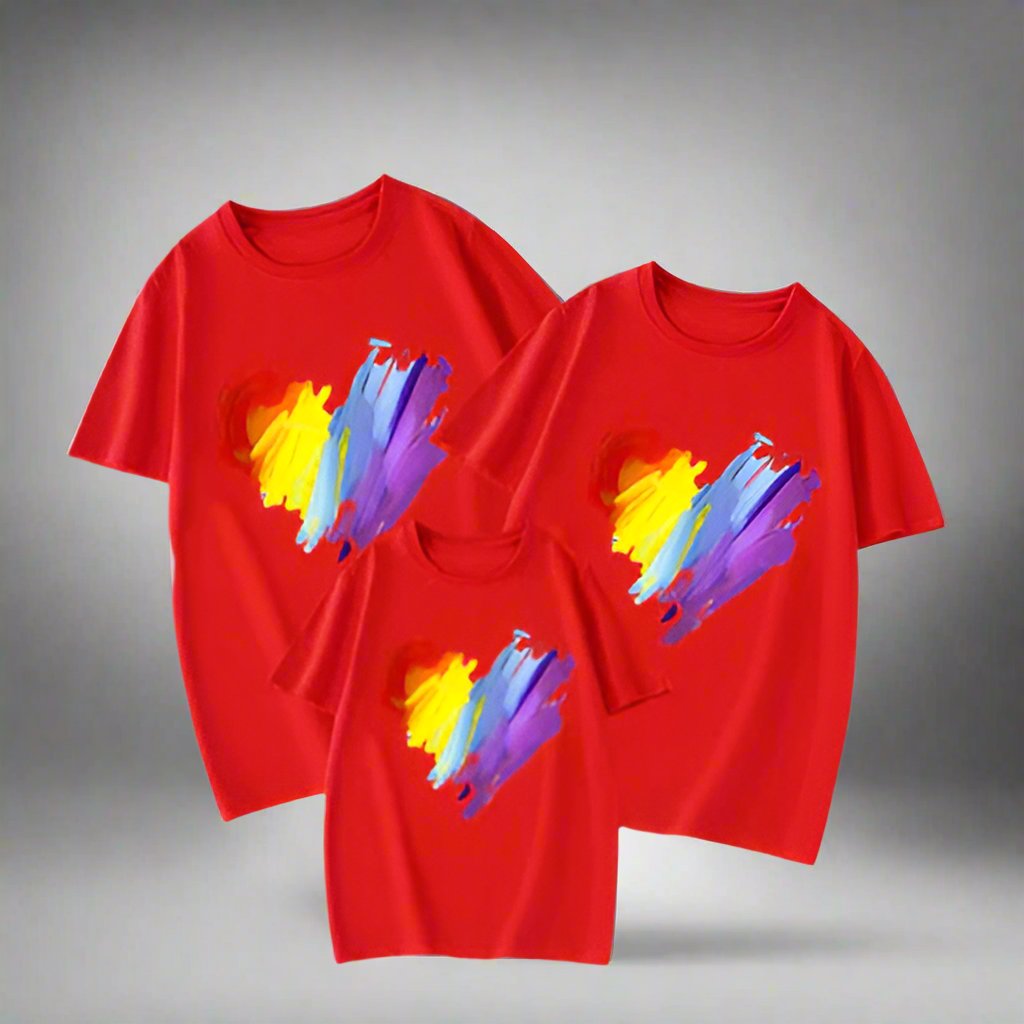 Set of family t-shirts featuring a rainbow heart print with brush stroke effect in bold colors