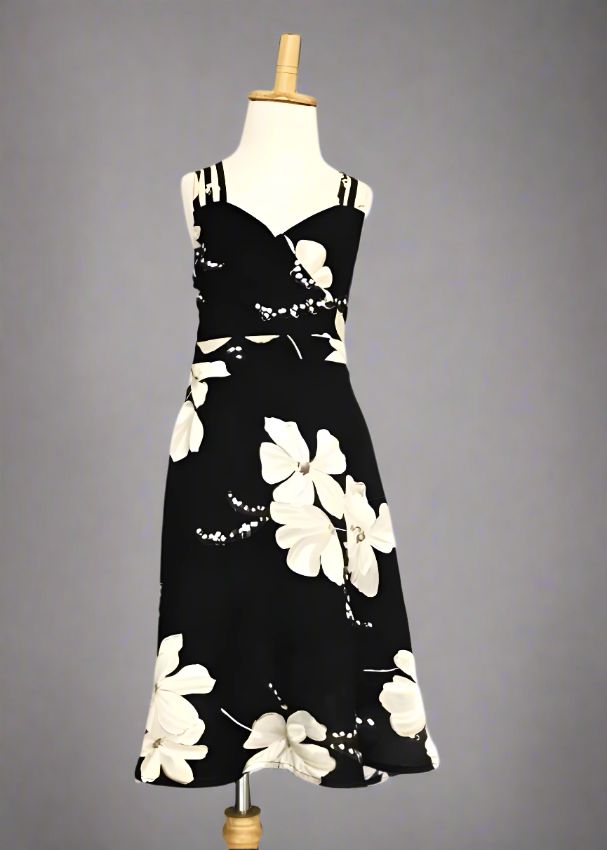 Mommy and daughter in black floral dresses enjoying a summer vacation