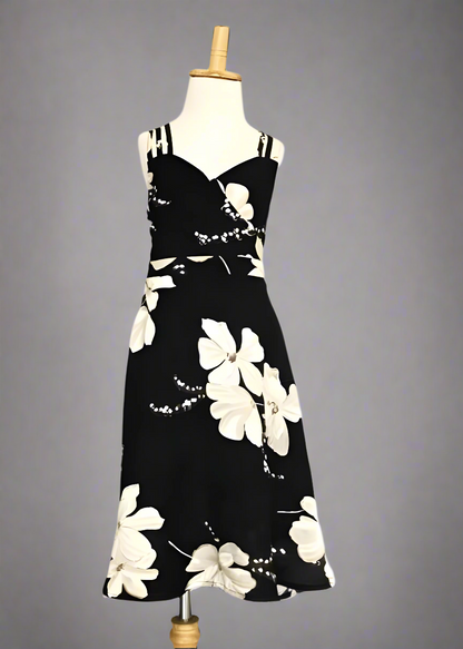 Mommy and daughter in black floral dresses enjoying a summer vacation