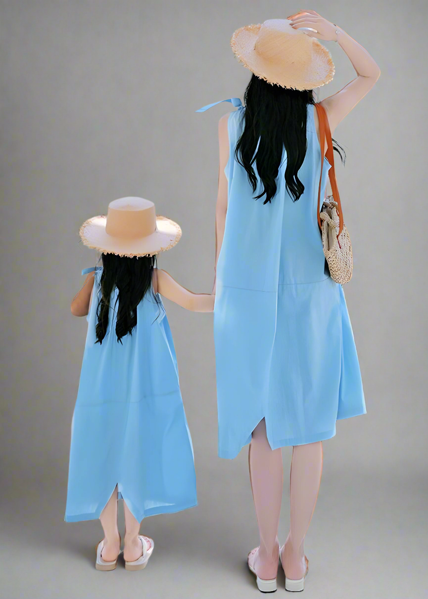 Stylish matching blue summer dresses for mother and daughter, ideal for beach or park visit
