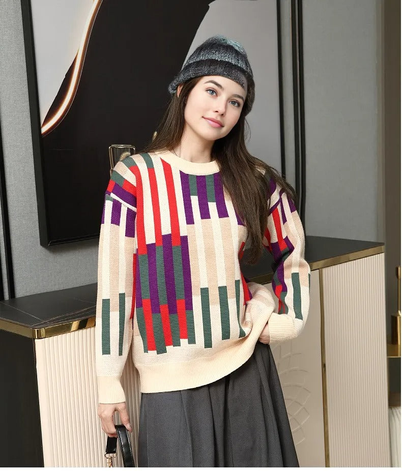 Vibrant striped knit sweater in red, green, and purple laid flat, designed for matching family outfits