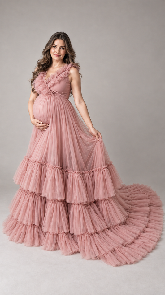 Pregnant woman in a dusty rose ruffle V-neck tulle maternity gown in a photo studio