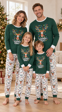 Family in matching dark green Lights Out! reindeer pajama tops, worn with cream reindeer and string-light print pants.