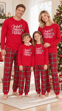 Family in matching red pajama tops with white Joyful Merry Blessed script, worn with red plaid pants.