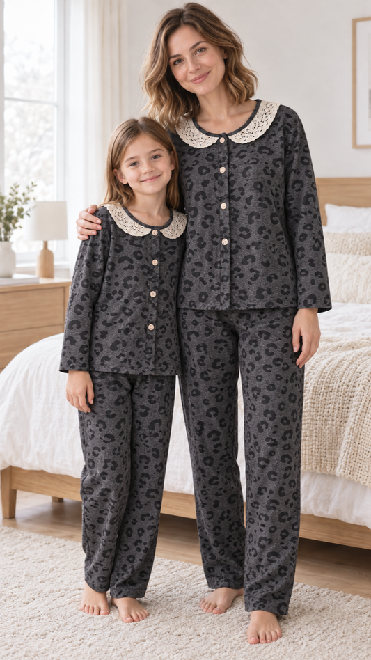 Mom and daughter in matching charcoal leopard button-up velvet pajamas with cream lace collars.