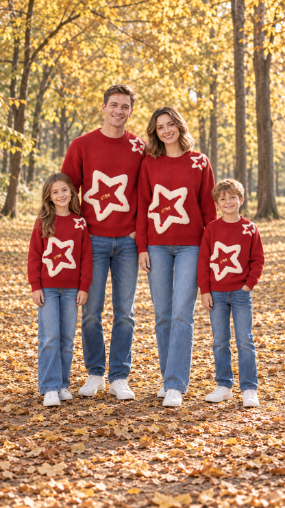 Family in matching red knit sweaters with a big fuzzy cream star and red pom-poms on the front.