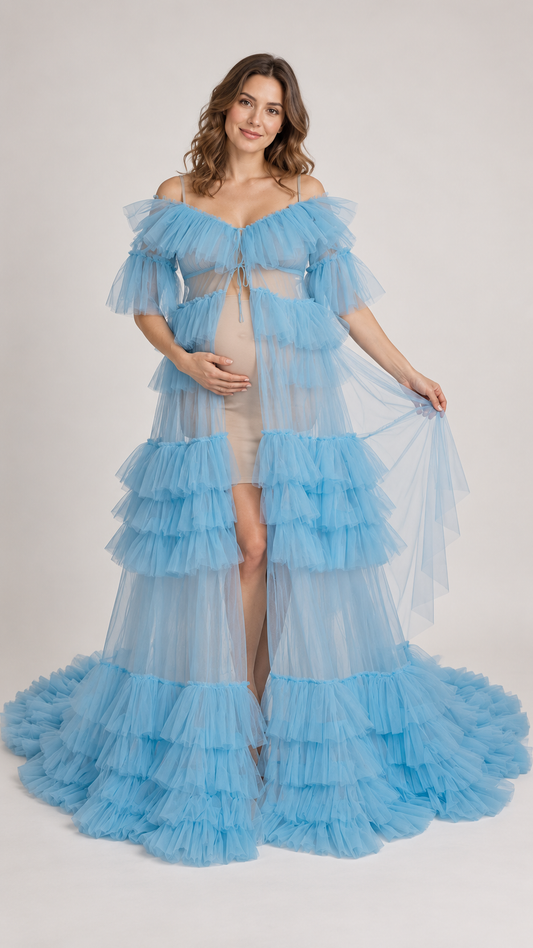 Pregnant woman in a sky blue sheer tiered ruffle tulle maternity robe gown in a photo studio