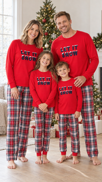 Family in matching red LET IT SNOW pajama tops, worn with red, white, and navy plaid pants.