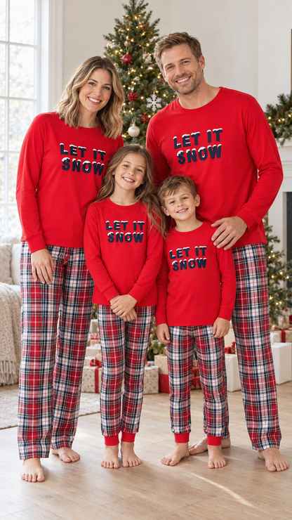 Family in matching red LET IT SNOW pajama tops, worn with red, white, and navy plaid pants.