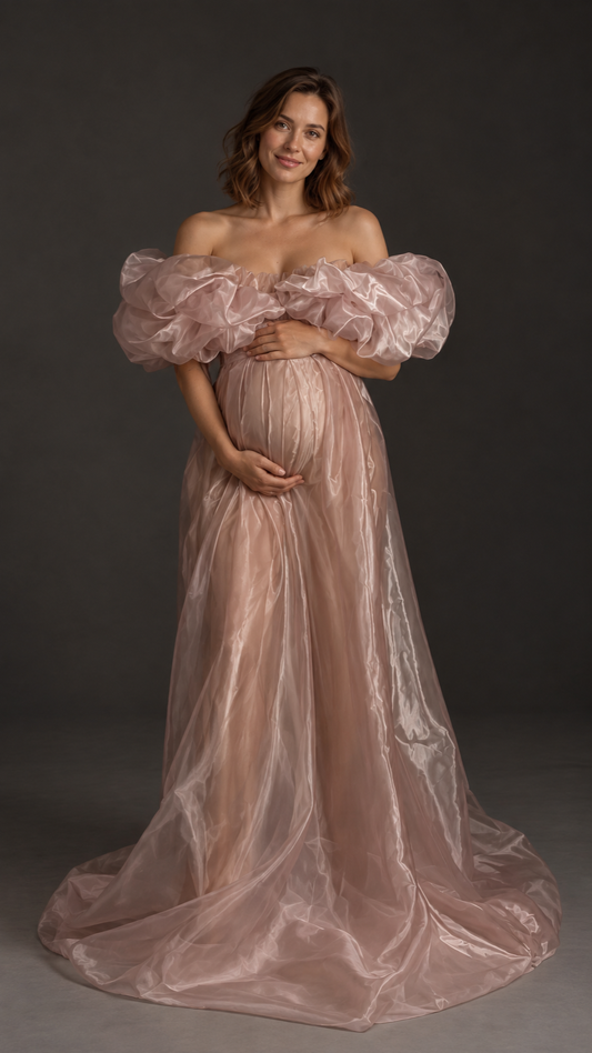 Pregnant woman in a dusty rose organza off-shoulder maternity gown with puffed sleeves in a photo studio