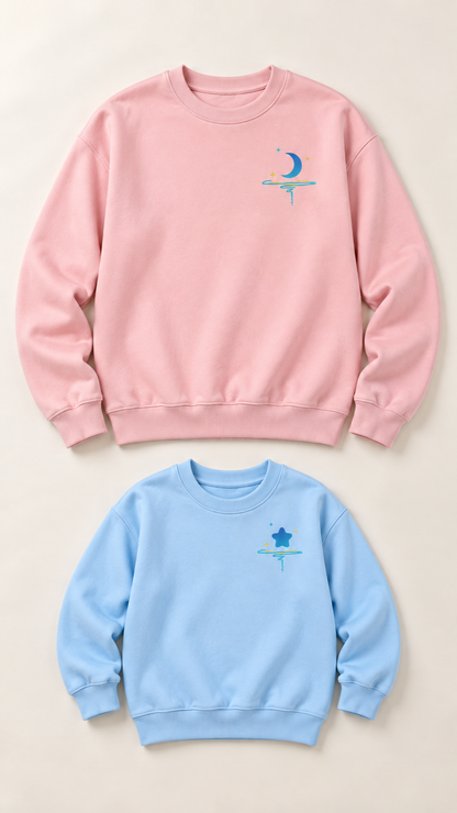 Moon and Star matching sweatshirts for an adult and a child, laid out without models.