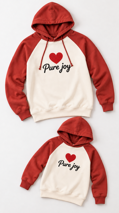 Pure Joy Heart matching sweatshirts for an adult and a child, laid out without models.