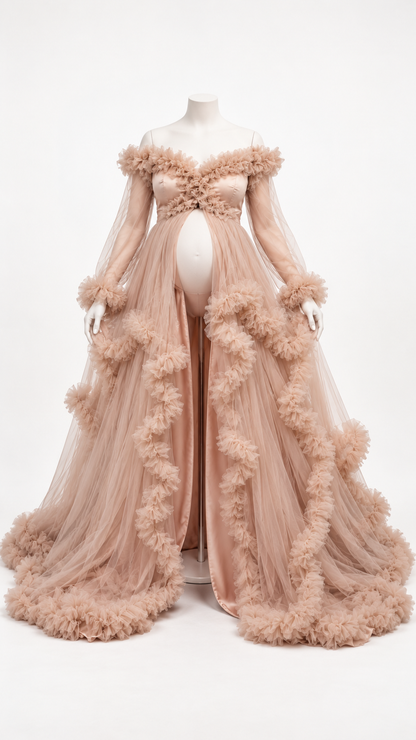 Nude blush off-shoulder maternity gown with long sheer sleeves and ruffled tulle skirt on a dress form