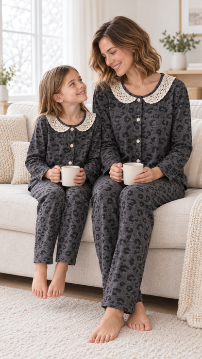 Family relaxing together at home in matching Charcoal Leopard Lace Christmas pajamas.