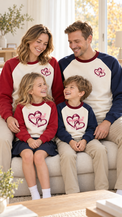 Family relaxing together at home in matching Eternal Bliss Hearts sweatshirts.