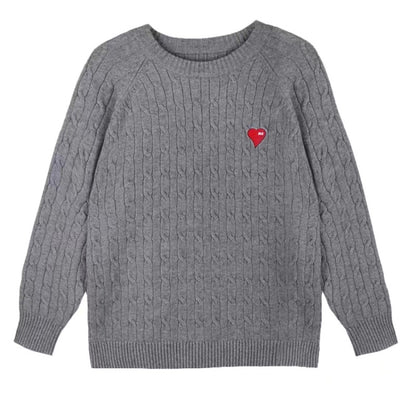 Two children wearing matching cable knit sweaters with heart details in red and white, ideal for sibling outfit sets