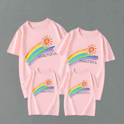 Colorful family matching outfits featuring rainbow and sun design