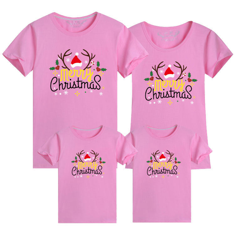 Coordinated family t-shirts in pink with festive Merry Christmas text and illustrations