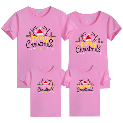 Coordinated family t-shirts in pink with festive Merry Christmas text and illustrations