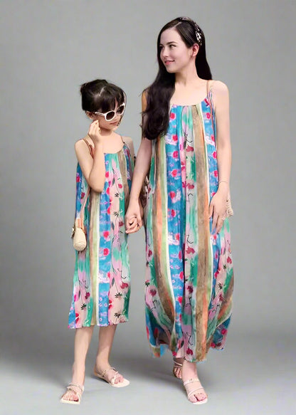 Mother and daughter wearing matching boho floral striped dresses