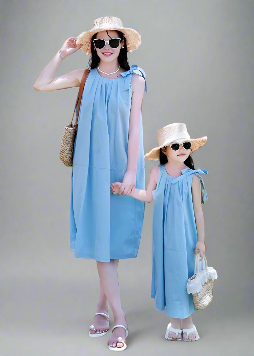 Mother and daughter wearing coordinated blue sundresses, casual and chic summer style