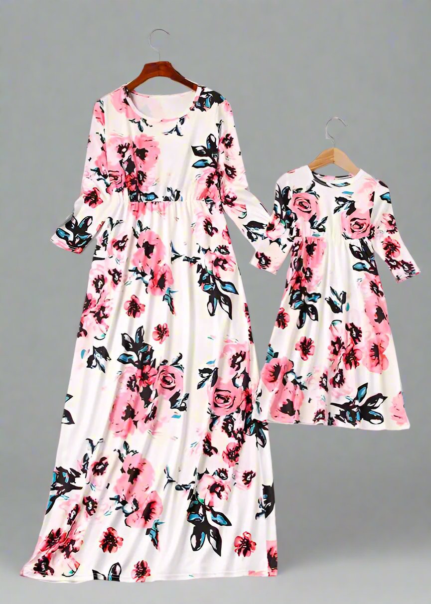 Mom and daughter in stylish matching white floral dresses, ideal for spring and summe