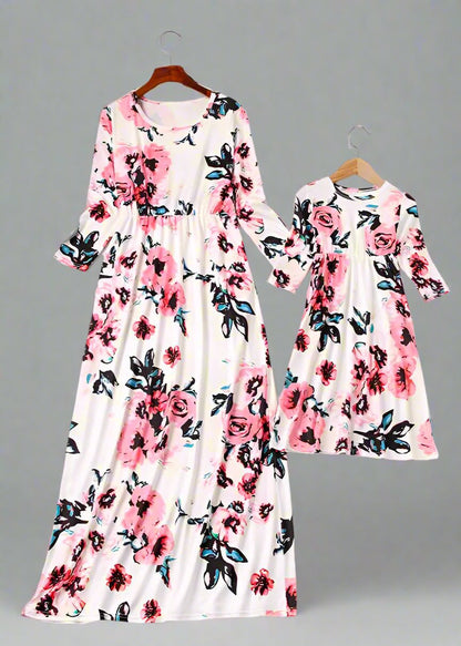 Mom and daughter in stylish matching white floral dresses, ideal for spring and summe